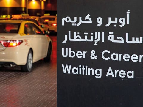 A taxi rank sign for Uber and Careem drivers stands at the Mall of the Emirates.