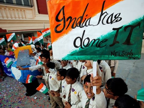 Students cheer as they raise flags to celebrate after India shot down one of its satellites in space with an anti-satellite missile in a test, inside their school premises in Ahmedabad. 