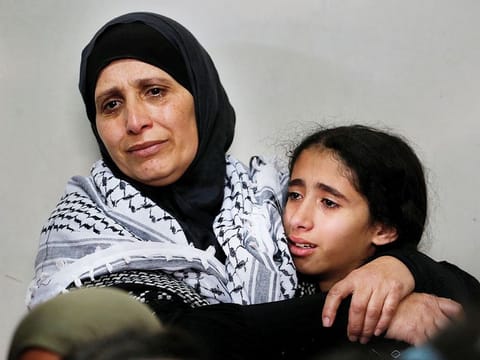 Relatives of Palestinian volunteer paramedic Sajed Mezher who was killed by Israeli troops, mourn during his funeral in Bethlehem in the Israeli-occupied West Bank March 27, 2019.