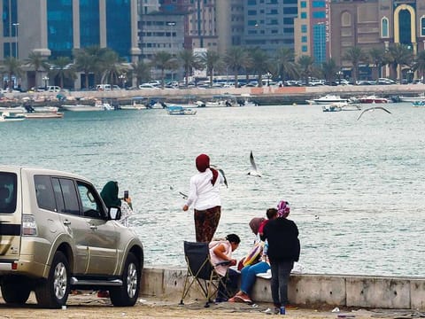 People enjoy the rainy weather in Sharjah. 