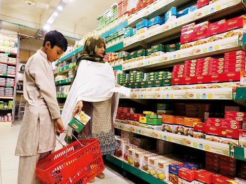 A woman shops for grocery items at a store in Peshawar. Pakistan's Monetary policy remains accommodative as inflationary pressures have eased in recent months. The policy rate remained unchanged at 7 per cent from July 2020 to August 2021.