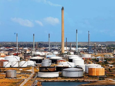 A refinery on the island of Curacao. Crude rose along with US equities after a report showed domestic hiring rebounded more than forecast in March.