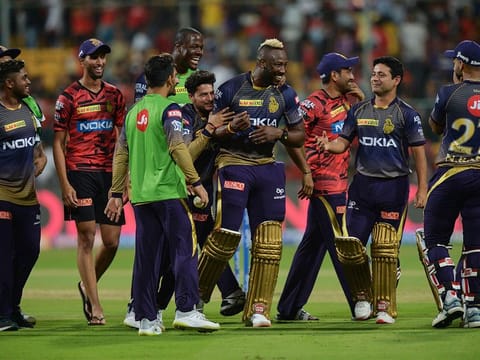 Kolkata Knight Riders teammates greet batsman Andre Russell (C) after he led the team's victory during the 2019 Indian Premier League (IPL) Twenty20 cricket match between Royal Challengers Bangalore and Kolkata Knight Riders at The M. Chinnaswamy Stadium in Bangalore on April 5, 2019.  Kolkata Knight Riders chased and won a target of 206 runs set by Royal Challengers with five wickets in hand. 