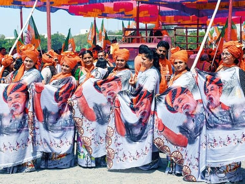BJP supporters wear saris with PM Narendra Modi’s portrait in Surat. A flurry of sexist remarks in recent days has drawn voter ire. 