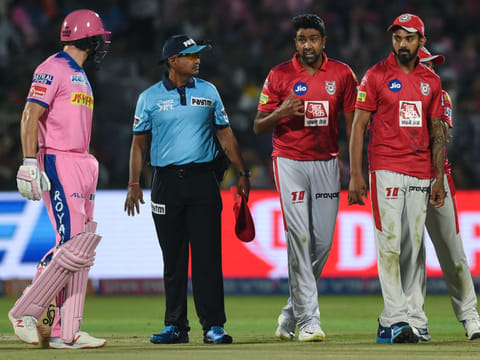 In this file photo taken on March 25, 2019 Rajasthan Royals' Jos Buttler (L) exchanges words with Kings XI Punjab's Ravichandran Ashwin (2nd R) during the 2019 Indian Premier League (IPL) Twenty20 cricket match between Rajasthan Royals and Kings XI Punjab at the Sawai Mansingh Stadium in Jaipur. 
