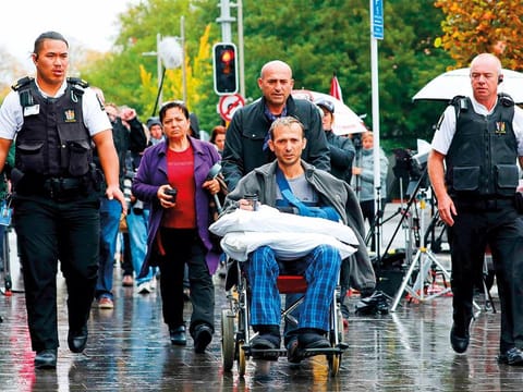 Temel Atacocugu (C), a survivor of the March 15 twin mosque massacre, leaves the Christchurch District Court on April 5, 2019 after alleged gunman Brenton Tarrant, accused of shooting dead 50 Muslims during the March 15 attack on two mosques, appeared for his hearing via audio-visual link from a maximum-security prison in Auckland. 