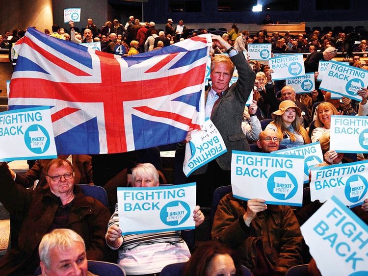 Supporters of The Brexit Party hold placards