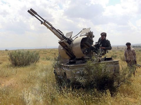 Fighters hold a position west of the city of Aziziah, some 60 kilometres southwest of the Libyan capital Tripoli
