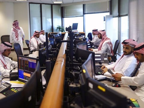 Employees at Alawwal Bank monitor financial data on the bank’s trading floor in Riyadh. Illustrative image. 