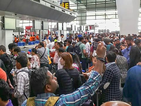 Air India flight passengers stranded at the Indira Gandhi International Airport, in New Delhi, on Saturday, April 27, 2019. 