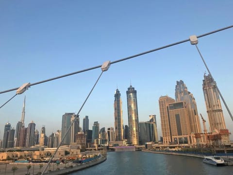 Dubai skyline is seen from the Victory Bridge at Dubai Water Canal. 
