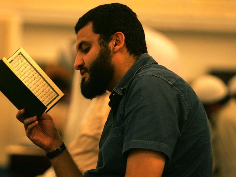 OPN_Man_reading_Quran-1556713548485
