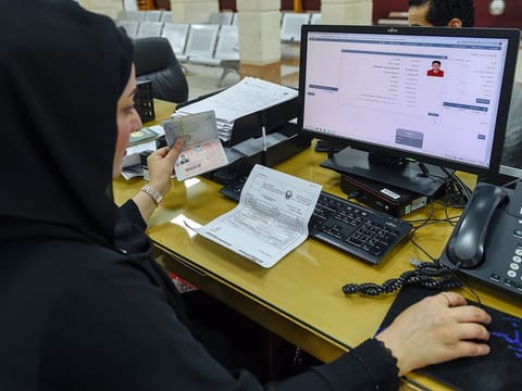 An employee at work at the General Directorate of Residency and Foreign Affairs (GDRFA) in Dubai.  