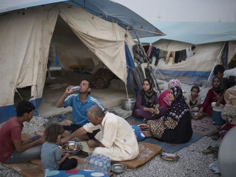 File photo: An internally displaced Iraqi family from Saladin breaks their day long fast during their first Ramadan iftar in the newly opened Ashti camp on June 24, 2015.