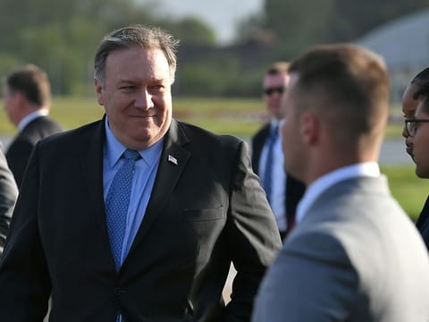 U.S. Secretary of State Mike Pompeo walks to board a plane before departing from London Stansted Airport, north of London, Britain May 9, 2019.