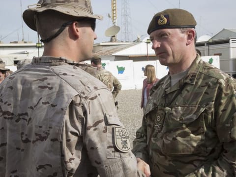 British Army Maj. Gen. Christopher Ghika, deputy commander for Strategy and Information, Combined Joint Task Force - Operation Inherent Resolve (CJTF-OIR), shakes hands with a Spanish soldier during a transfer of authority ceremony at the Besmaya Range Complex, Iraq, Nov. 22, 2018. At Besmaya, the Coalition provides training for the Iraqi Security Forces (ISF). 