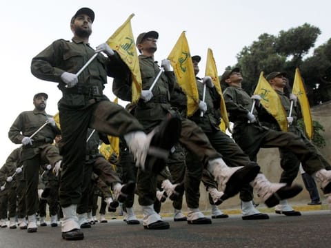 Hezbollah militants march in a parade in a file photo. Some — militant groups, particularly Hezbollah, have been weakened in recent months, even as they remain capable of escalating the conflict.