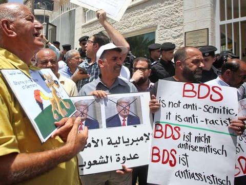 Protesters stage a demonstration outside Germany's Representative Office in Ramallah in the Palestinian West Bank on May 22, 2019, following the Bundestag's (German parliament) condemnation of the Boycott, Divestment, Sanctions (BDS) movement as anti-Semitic.