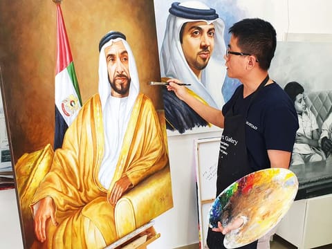 Jack Lee, the Abu Dhabi-based Chinese artist, with his paintings of late Shaikh Zayed and other UAE leaders. Lee said art was an essential and powerful tool for cultural enlightenment.