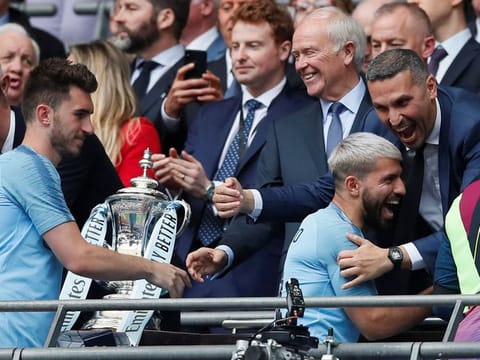 Manchester City Chairman Khaldoon Al Mubarak (extreme right) celebrates with Sergio Aguero during the presentation ceremony for winning the FA Cup.
