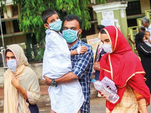 People wear safety masks as a precautionary measure after the Nipah virus outbreak at Kozhikode Medical College, in Kerala, on Friday.