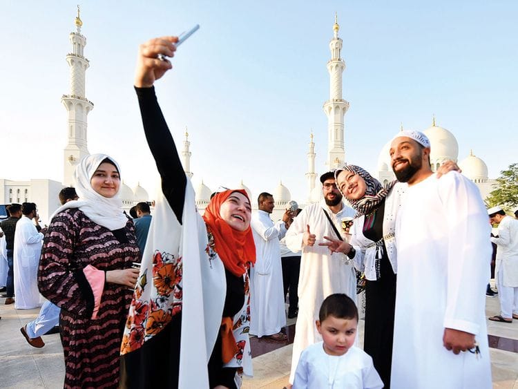 A family poses for a selfie after Eid prayers 