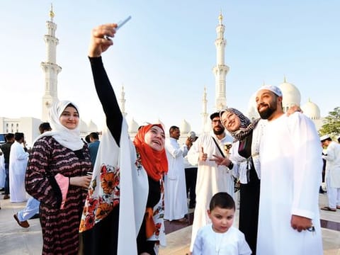 A family poses for a selfie after Eid prayers at the Shaikh Zayed Grand Mosque in Abu Dhabi.