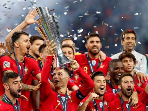 Portugal players celebrate with their trophy after defeating the Netherlands 1-0 in the UEFA Nations League final match at the Dragao stadium in Porto, Portugal, Sunday, June 9, 2019.