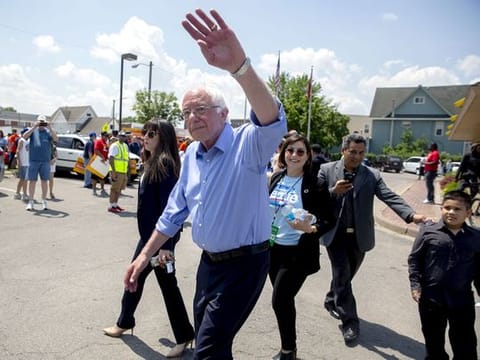 Senator Bernie Sanders, an independent from Vermont and 2020 presidential candidate, center, waves while leaving McDonald's Corp. Workers Union Action event ahead of the Iowa Democratic Party Hall of Fame event in Cedar Rapids, Iowa.