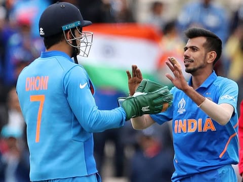 India's Yuzvendra Chahal, right, celebrates with teammate MS Dhoni the dismissal of South Africa's Andile Phehlukwayo during the World Cup match between them at the Hampshire Bowl in Southampton, on June 5, 2019. 