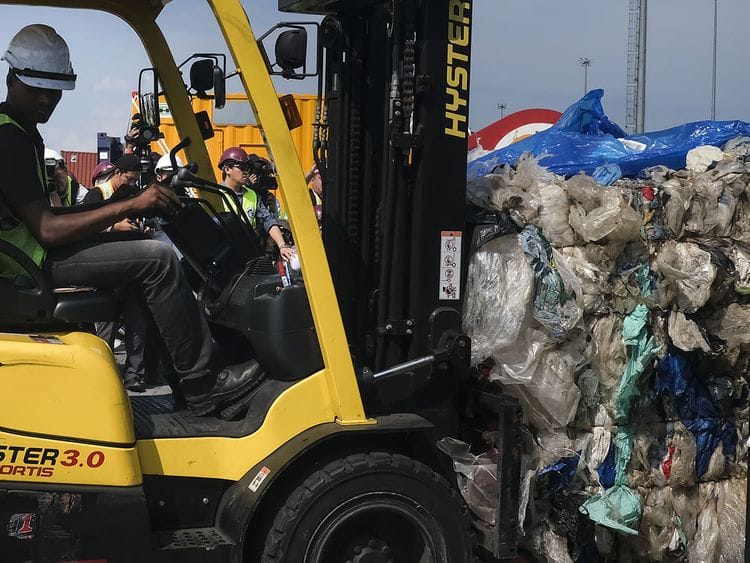 A Westport Holdings Bhd employee uses a forklift to move trash