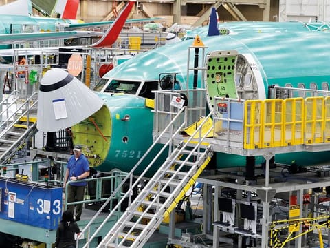 A Boeing 737 MAX 8 is shown on the assembly line at Boeing’s 737 assembly facility in Renton, Washington. A government report says Boeing did not give regulators documents about changes it made in a key system blamed in two deadly crashes of its 737 Max jet. 