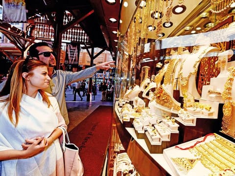 Customers look at jewellery in the Deira Gold Souq. The overnight increase comes at quite an inconvenient moment for resident shoppers.