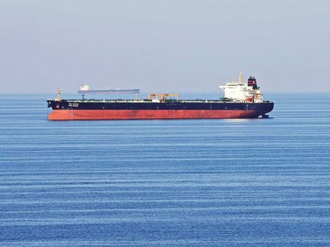 An oil tanker passes through the Strait of Hormuz. Companies are charging at least $180,000 in premiums to go to the Arabian Gulf.
