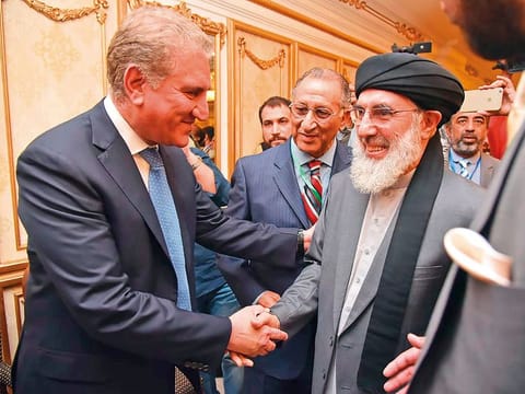 Foreign Minister Shah Mahmoud Qureshi (left) greets Afghan warlord Gulbuddin Hekmatyar in Bhurban yesterday.