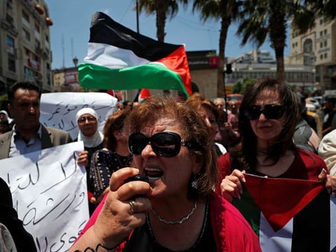 Palestinians take part in a protest against the U.S.-led economic workshop for Mideast plan that is hosted by Bahrain, in Ramallah in the Israeli occupied West Bank