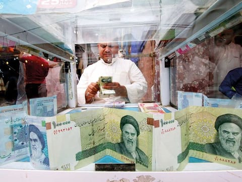 FILE: A man counts Iranian rials at a currency exchange shop, before the start of the U.S. sanctions on Tehran, in Basra, Iraq November 3, 2018. Picture taken November 3, 2018. 