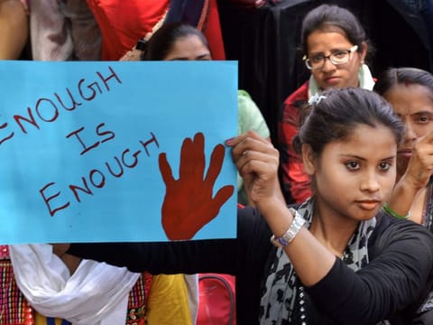 New Delhi: Women and children druing a dharna aganist rape incidents at Rajghat in New Delhi on Friday. PTI Photo  (PTI4_13_2018_000116B)