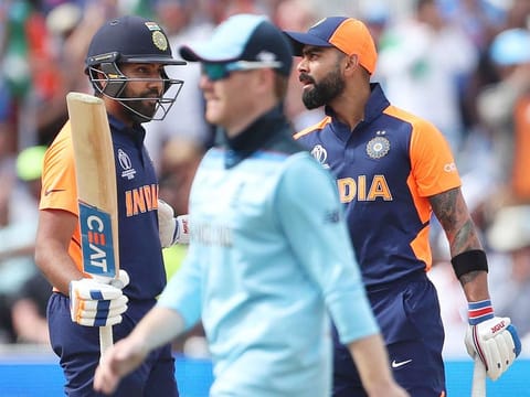 England's captain Eoin Morgan, centre, walks past India's Virat Kohli, right, and Rohit Sharma during the World Cup match between them at Edgbaston in Birmingham. 