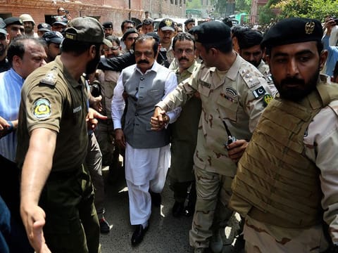 File photo: Officers of Pakistan's police and Anti-Narcotics Force escort opposition lawmaker Rana Sanaullah Khan, centre, to a court in Lahore, Pakistan.