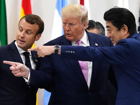 French President Emmanuel Macron, President Donald Trump as Japanese Prime Minister Shinzo Abe speak before a working session at the G-20 summit in Osaka, Japan, on June 28, 2019. 