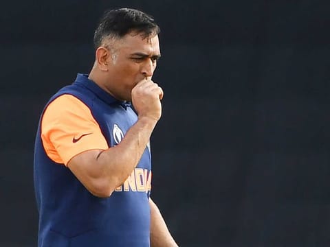 India's MS Dhoni reacts after being hit on the thumb while batting during the World Cup group stage match against England at Edgbaston in Birmingham, on June 30, 2019. 