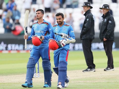 Afghanistan's Mujeeb Ur Rahman, left, and Sayed Shirzad leave the field after their loss against West Indies in the World Cup match at Headingley in Leeds. 
