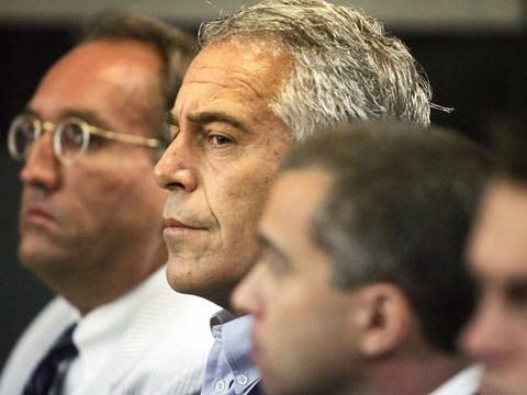 Jeffrey Epstein, center, is shown in custody in West Palm Beach, Florida, in this July 30, 2008 file photo.