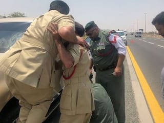 Four Dubai Police officials personally helped a UAE resident change flat tyre