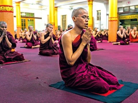 Monks pray in the Bengala monastery in Myanmar. Incited by a powerful network of monks, Buddhists have entered 
the era of militant tribalism. New York Times