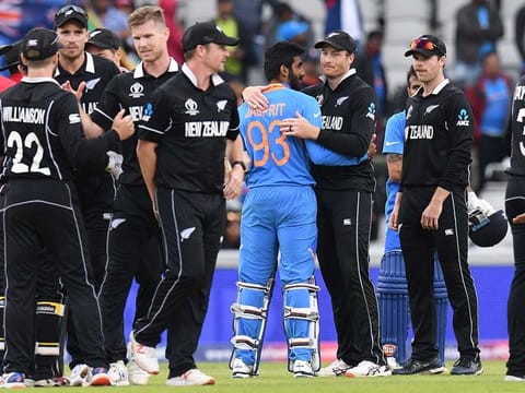 New Zealand's Martin Guptill (C-R) embraces India's Jasprit Bumrah after winning the World Cup first semi-final at Old Trafford in Manchester. 
