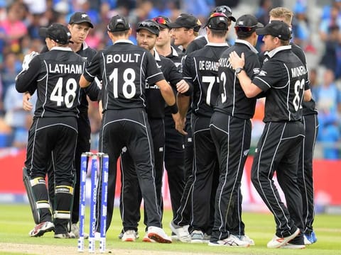 New Zealand's captain Kane Williamson (C) and teammates celebrate victory during the World Cup semi-final against India at Old Trafford in Manchester. 