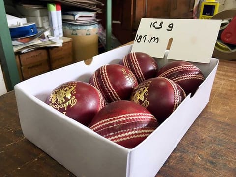 A box of freshly polished Dukes balls that will be used for the Ashes tests is displayed at the British Cricket Balls Ltd in Walthamstow, London. 