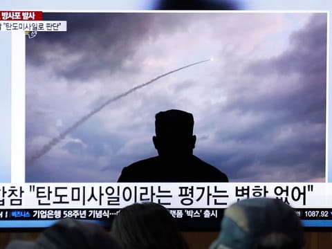 People watch a TV showing an image of North Korea's a multiple rocket launch during a news program at the Seoul Railway Station in Seoul, South Korea.